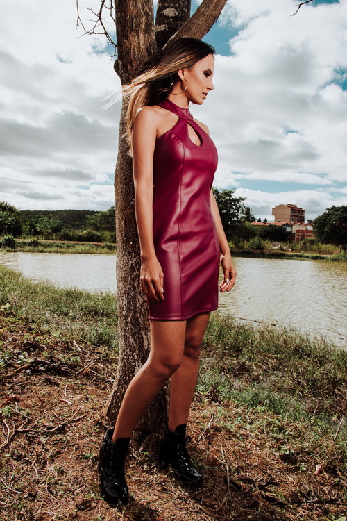 Girl in red leather skirt by the river Stock Photo