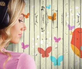 Girl listening to music standing in front of cartoon painted wall background Stock Photo 01