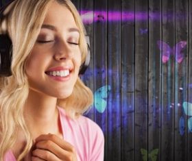 Girl listening to music standing in front of cartoon painted wall background Stock Photo 02