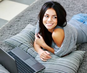 Girl lying on the carpet on the internet Stock Photo 01