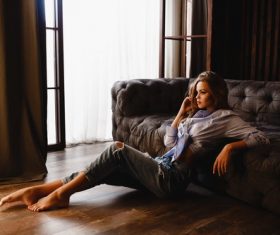 Girl posing in front of the sofa Stock Photo