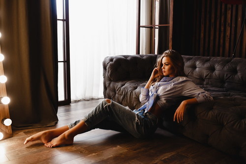 Girl posing in front of the sofa Stock Photo