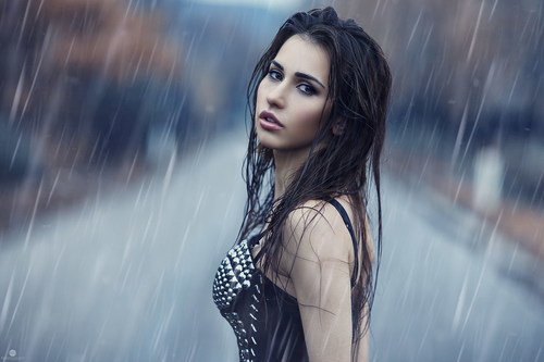Girl standing in the rain Stock Photo