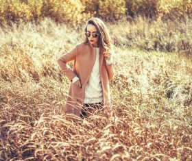Girl standing in the withered grass Stock Photo
