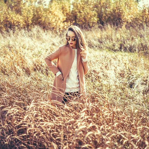 Girl standing in the withered grass Stock Photo