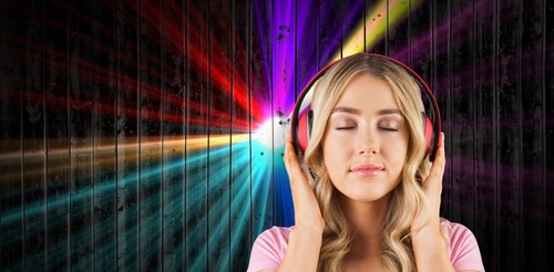 Girl with closed eyes listening to music Stock Photo