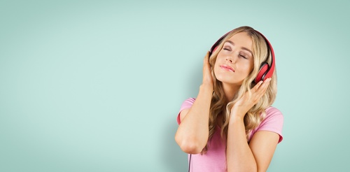 Girl with headphones closed eyes listening to music Stock Photo