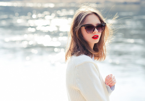 Girl with sunglasses and red lipstick on the lakeside Stock Photo