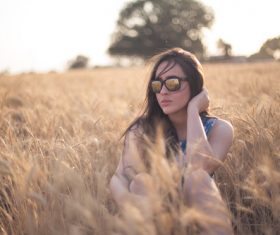 Girl with sunglasses in the wheat field Stock Photo