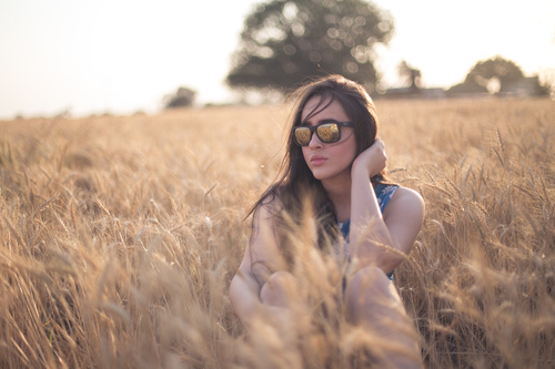 Girl with sunglasses in the wheat field Stock Photo