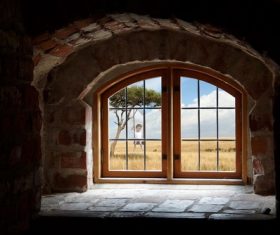 Grassland scene outside of brick houses window Stock Photo