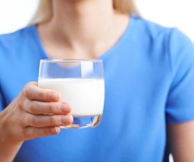 Hand holding a glass of milk Stock Photo 01