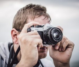Hand press the shutter to take pictures of people Stock Photo