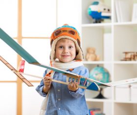 Happy child holding paper glider Stock Photo