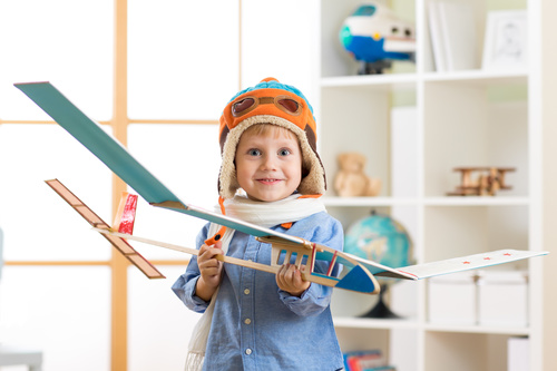 Happy child holding paper glider Stock Photo