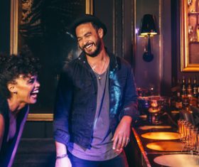 Happy men and women in front of the bar Stock Photo 01