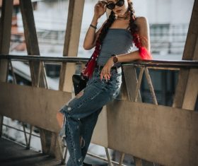 Hipster girl standing on the bridge posing Stock Photo