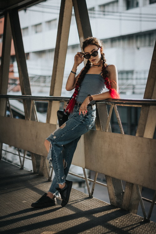 Hipster girl standing on the bridge posing Stock Photo