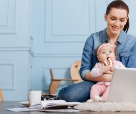 Housewife holding a child online Stock Photo 01