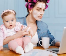Housewife holding a child online Stock Photo 02