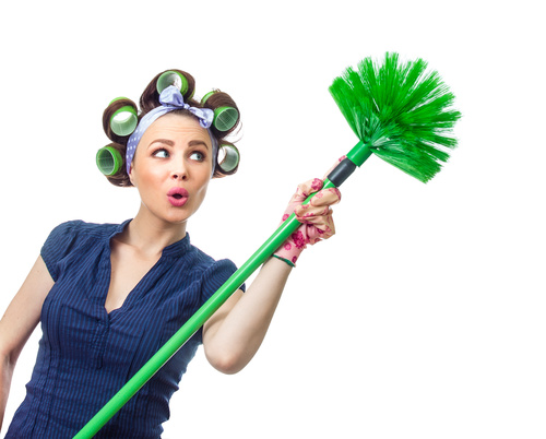 Housewife holding broom Stock Photo