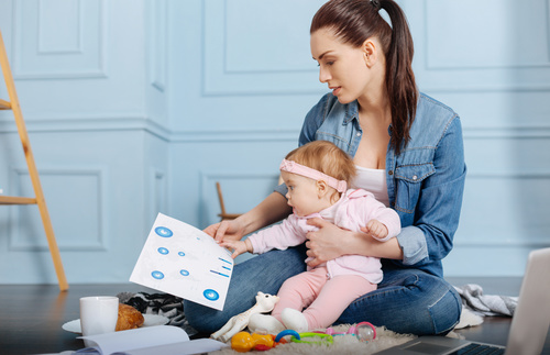 Housewife holding child looking at chart Stock Photo 01