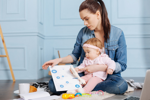 Housewife holding child looking at chart Stock Photo 02
