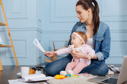 Housewife holding child looking at chart Stock Photo 03
