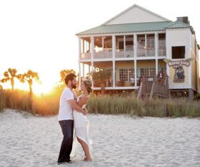 Hugging couple in front of the beach hotel Stock Photo