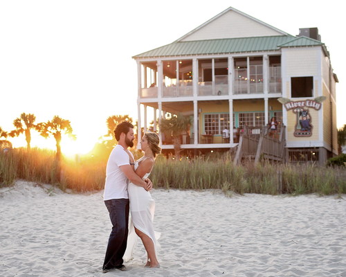 Hugging couple in front of the beach hotel Stock Photo