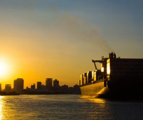 Large freighter moored in the dock at sunset Stock Photo