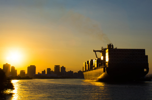 Large freighter moored in the dock at sunset Stock Photo