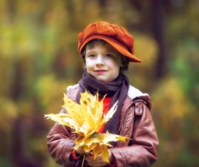 Little boy holding dead leaves Stock Photo