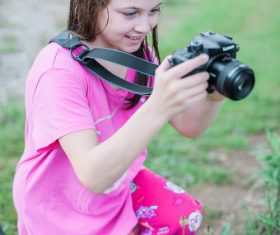 Little girl taking a photo with camera Stock Photo