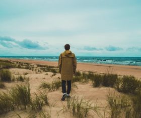 Lonely man walking on seaside Stock Photo