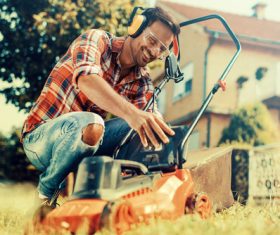 Man cleans the hand-push lawn mower Stock Photo 10
