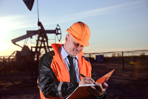 Man doing oil production record Stock Photo