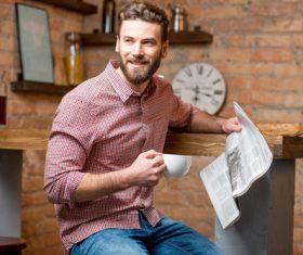Man drinking coffee and reading newspaper Stock Photo 02