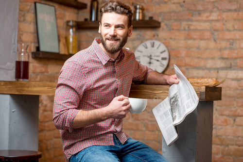 Man drinking coffee and reading newspaper Stock Photo 02