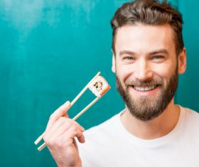 Man eating sushi Stock Photo