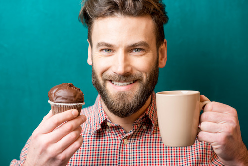 Man holding coffee and cake Stock Photo