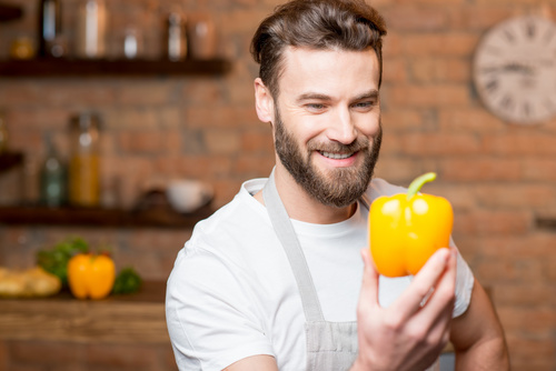 Man holding colorful pepper Stock Photo
