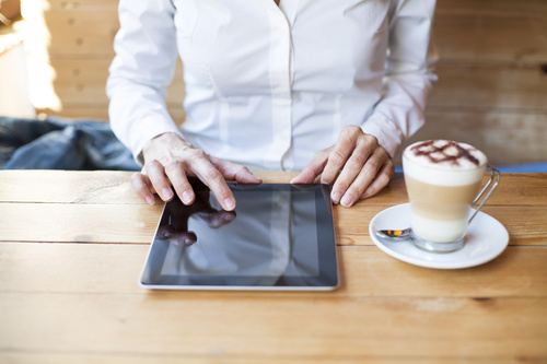Man in cafe Uses tablets pc Stock Photo