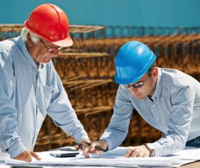 Man looking at drawings at construction site Stock Photo