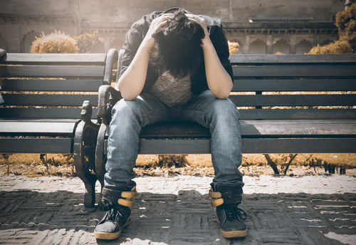 Man sad and holding his head Stock Photo