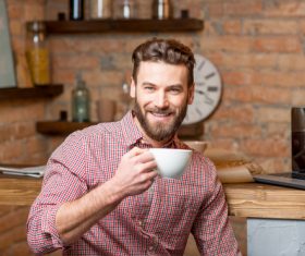 Man sitting at home drinking coffee Stock Photo