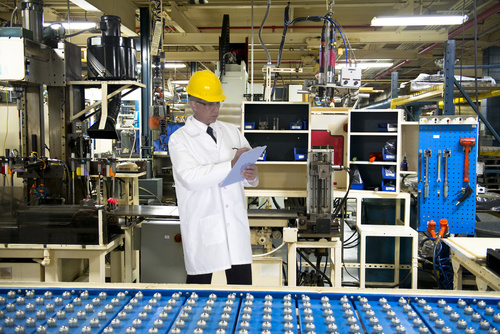 Man who made record before the factory production line Stock Photo