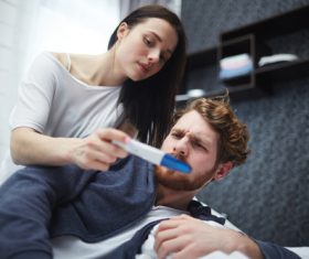 Married couple looking at positive pregnancy test Stock Photo 03