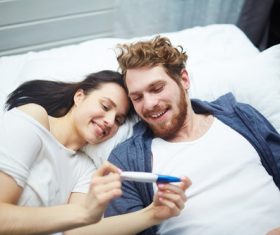 Married couple looking at positive pregnancy test Stock Photo 05