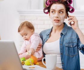 Mother holding child answering the phone Stock Photo 01